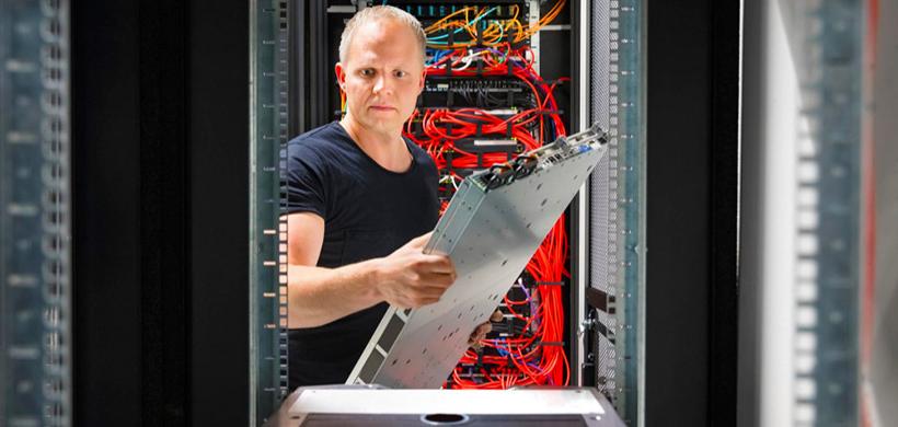 data center shutdown checklist - man packing data center equipment